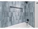 Stylish bathtub with modern blue tile surround and built-in niche at 3790 Shirebrook Dr # 167, Las Vegas, NV 89115
