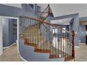 Carpeted staircase with ornamental iron spindles and wood handrail at 4063 Lower Saxon Ave, North Las Vegas, NV 89085