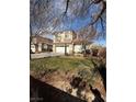 Charming two-story home with attached garage and well-manicured front lawn at 5214 Monterey Park Cir, Las Vegas, NV 89146