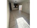 Bright living room featuring durable tile flooring, and sliding door access to the backyard at 5214 Monterey Park Cir, Las Vegas, NV 89146