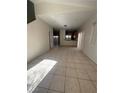 Open-concept living room with tile flooring leading to an adjacent kitchen area at 5214 Monterey Park Cir, Las Vegas, NV 89146