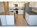 Bright kitchen boasts granite countertops, stainless steel appliances, and modern white cabinets at 5269 Acadia Leaf St, Las Vegas, NV 89166