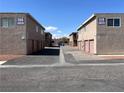 View of two apartment buildings with garages, showcasing a tidy complex layout and ample parking at 579 Roxella Ln # D, Las Vegas, NV 89110