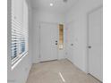 Bright entryway with tile flooring, a side window, and multiple white doors at 648 Sumatra Pl, Henderson, NV 89011