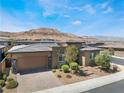 Stunning single-story house featuring desert landscaping and a brick driveway at 6801 Steel Mist St, Las Vegas, NV 89148