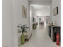 Bright hallway with tile flooring leads to the dining and living areas at 8729 Marcana St, Las Vegas, NV 89166