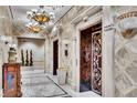 Elegant lobby area featuring ornate chandeliers, marble flooring, and elevator access at 9103 Alta Dr # 1502, Las Vegas, NV 89145