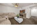 Cozy living room features comfortable seating, a ceiling fan, and a modern entertainment center at 378 Colleen Ct # G, Mesquite, NV 89027