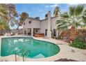 Backyard pool with a spa, covered patio area, mature trees, and a block fence at 3886 Green Leaf Dr, Las Vegas, NV 89120