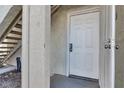 The white front door is a welcoming entrance, offering a peek inside and complemented by textured walls at 4404 W Lake Mead Blvd # 102, Las Vegas, NV 89108