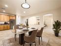 Elegant dining room with modern table, chairs, and seamless access to adjacent rooms at 6360 Bullring Ln, Las Vegas, NV 89130