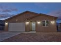 Charming single-story home featuring a two-car garage and tile roof at twilight at 790 E Basin, Pahrump, NV 89060
