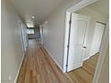 Long hallway featuring wood-look flooring and doors leading to other rooms in the home at 790 E Basin, Pahrump, NV 89060
