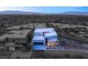 Aerial view of a modern home in a planned community with city views in the background at 805 Magnum Cliff Ct, Henderson, NV 89012