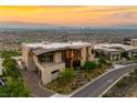 Contemporary home showcasing stunning city views, manicured landscaping, and elegant architectural design at 11 Rockstream Dr, Henderson, NV 89012