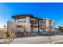 Modern home showcasing a unique architectural design with stone landscaping and a curved roofline at 11 Rockstream Dr, Henderson, NV 89012