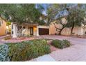 Lovely two-story home with a brick driveway, a beautiful porch, and fresh landscaping at 11017 Ladyburn Ct, Las Vegas, NV 89141