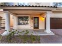 Inviting home entryway featuring decorative columns, a dark-colored door, and brick pavers at 11017 Ladyburn Ct, Las Vegas, NV 89141