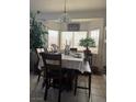 Cozy dining area with a table set for a meal and a bright bay window at 1562 Pimlico Hills St, Henderson, NV 89014