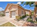 Charming home with a two-car garage, desert landscaping, and an inviting walkway at 1562 Pimlico Hills St, Henderson, NV 89014