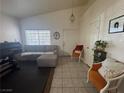 Bright living area with a neutral color palette, tile flooring, and comfortable seating at 1562 Pimlico Hills St, Henderson, NV 89014