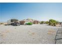Single-story house with a large, gravel-covered front yard and covered parking on the left at 1920 Silver St, Pahrump, NV 89048