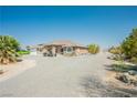 Single-story house with desert landscaping and a long gravel driveway at 1920 Silver St, Pahrump, NV 89048