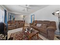 The living room features tile flooring, a ceiling fan, and neutral-colored walls at 214 Earl St, Las Vegas, NV 89101