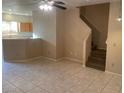 Inviting living room features tile flooring, ceiling fans and stairway to the second floor at 2637 Heathrow St, Las Vegas, NV 89135
