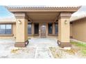 Inviting entrance with a tiled walkway, covered porch, and stylish exterior lighting at 3051 S Rainbow Ave, Pahrump, NV 89048