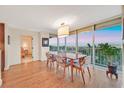Elegant dining room with hardwood floors and panoramic views through large windows at 3111 Bel Air Dr # 7D, Las Vegas, NV 89109