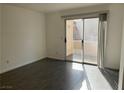 Bright living room featuring a sliding glass door to the outside and gray tile floors at 3119 Key Largo Dr # 204, Las Vegas, NV 89120