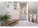Bright foyer with decorative tile flooring, staircase, and a charming entryway bench at 7029 Parrot Bay Way, Las Vegas, NV 89118