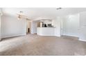 Spacious living room with carpet flooring and open layout to kitchen at 8600 W Charleston Blvd # 1043, Las Vegas, NV 89117