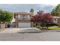 Two-story home featuring a three car garage, tiled roof and second story balcony at 3120 Stern Dr, Las Vegas, NV 89117
