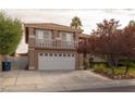 Two-story home featuring a three car garage, tiled roof and second story balcony at 3120 Stern Dr, Las Vegas, NV 89117
