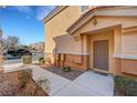 Townhouse entry with a front door, walkway, desert landscaping, and nearby parking at 10074 Aspen Rose St # 101, Las Vegas, NV 89183