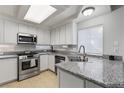 Updated kitchen featuring stainless steel appliances, granite counters and natural lighting at 10273 Grecian Laurel Ct, Las Vegas, NV 89183