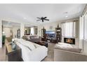 Comfortable living room boasts a ceiling fan, fireplace, and stylish furnishings for cozy relaxation at 10313 Aragon Crown Rd, Las Vegas, NV 89135