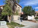 Charming two-story home featuring a well-maintained lawn, mature trees, and a two-car garage at 11147 Verismo St, Las Vegas, NV 89141