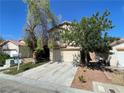 Charming two-story home featuring a well-maintained lawn, mature trees, and a two-car garage at 11147 Verismo St, Las Vegas, NV 89141