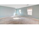 Expansive living room with carpet flooring, bright windows, and neutral paint at 11147 Verismo St, Las Vegas, NV 89141