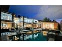 Expansive backyard featuring a large pool, hot tub, outdoor kitchen, and covered patio for outdoor enjoyment at 1704 Tangiers Dr, Henderson, NV 89012