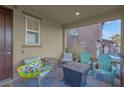 Cozy front porch with chairs, small table, and a view of the neighborhood at 193 Calabria Peak Ct, Henderson, NV 89012