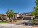 Beautiful home exterior showcasing a spacious driveway and lush landscaping at 2038 Cherry Creek Cir, Las Vegas, NV 89135