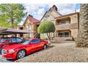 Exterior shot of condo building featuring mature tree, car ports, and private balconies at 2200 S Fort Apache Rd # 1007, Las Vegas, NV 89117