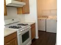 Practical kitchen setup with a gas range and convenient access to laundry appliances at 2736 Stargate St, Las Vegas, NV 89108