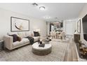 Comfortable living room featuring a couch, rug, and table with a view of the kitchen and a white front door at 2851 S Valley View Blvd # 1150, Las Vegas, NV 89102