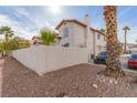 Beige stucco house with a red clay roof with a car in the driveway at 3866 Starfield Ln, Las Vegas, NV 89147