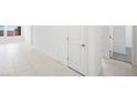 Bright hallway featuring tiled flooring and multiple doorways at 4485 E Brusca Way, Pahrump, NV 89061